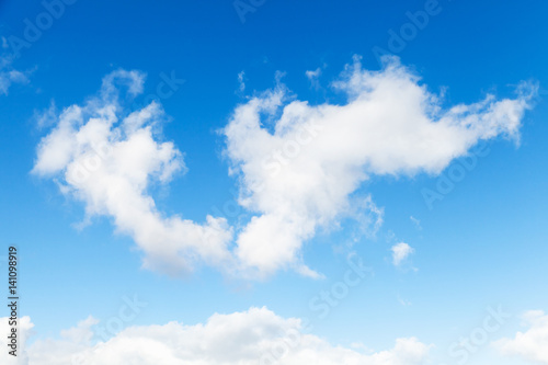 White cumulus clouds in blue sky