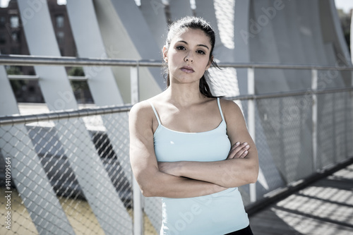 Quadro em tela attractive hispanic brunette woman looking cool and defiant after running workou