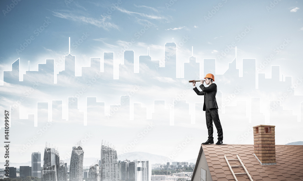 Engineer man standing on roof and looking in spyglass. Mixed med Engineer man standing on roof and looking in spyglass. Mixed med