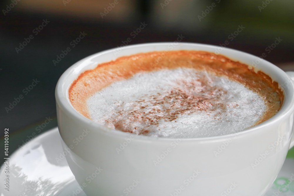close up coffee cappuccino on the wooden floor background