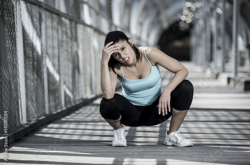 sport woman tired and exhausted breathing and cooling down after running