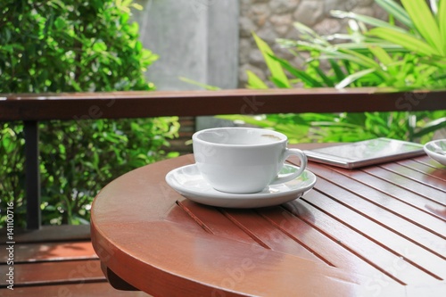 coffee cup on the wood floor background