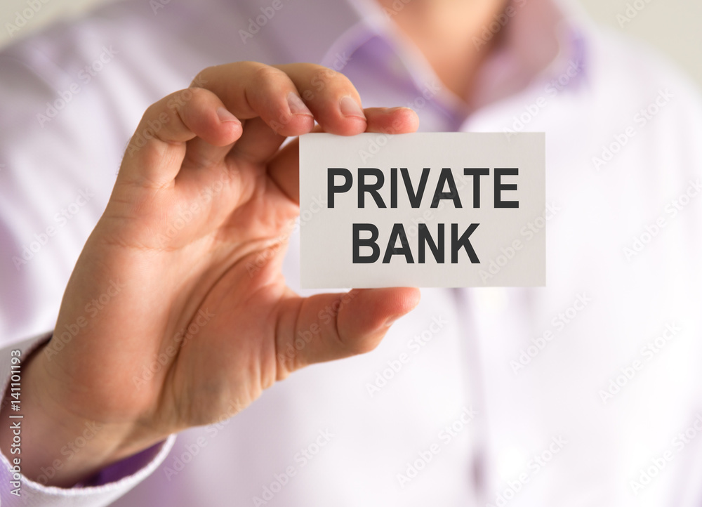 Businessman holding a card with PRIVATE BANK message Businessman holding a card with PRIVATE BANK message