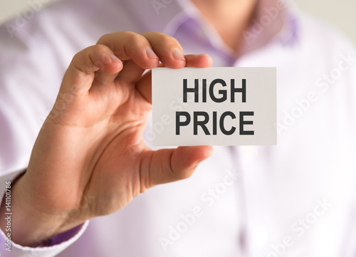 Businessman holding a card with HIGH PRICE message