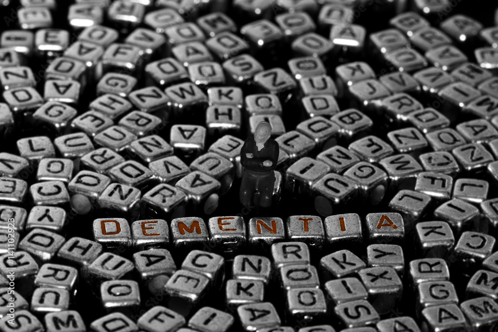 Letter blocks spelling dementia with scale model male pensioner