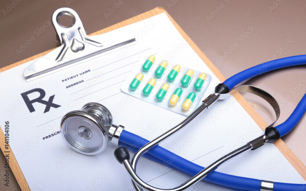 RX prescription, Red heart, asorted pils and a stethoscope on white background RX prescription, Red heart, asorted pils and a stethoscope on white background