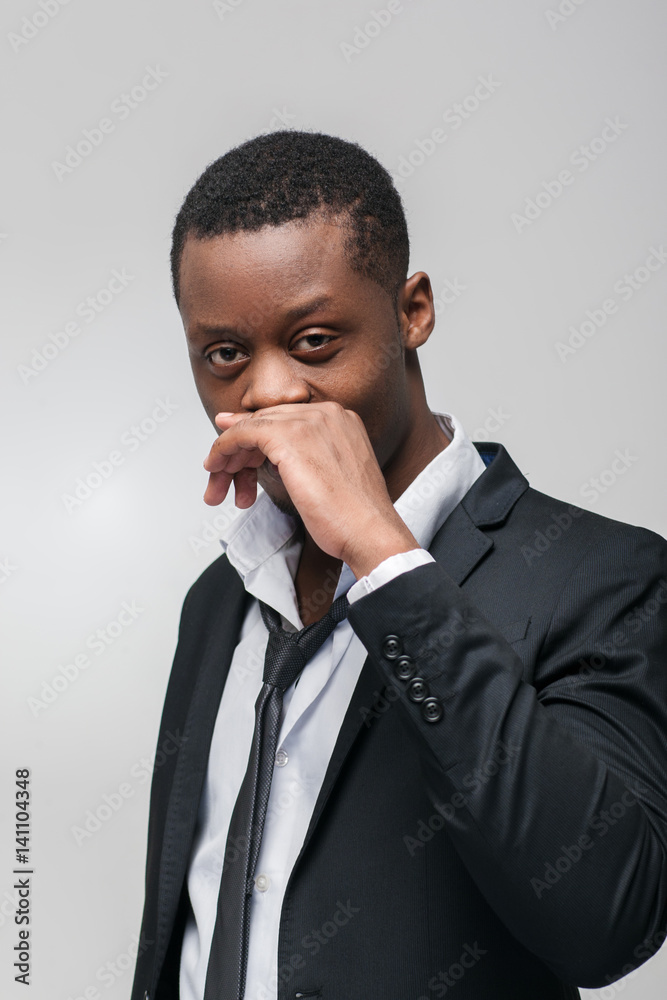 Afroamerican guy liar on grey background. Hiding truth, not telling, dishonest, sly, cunning Afroamerican guy liar on grey background. Hiding truth, not telling, dishonest, sly, cunning