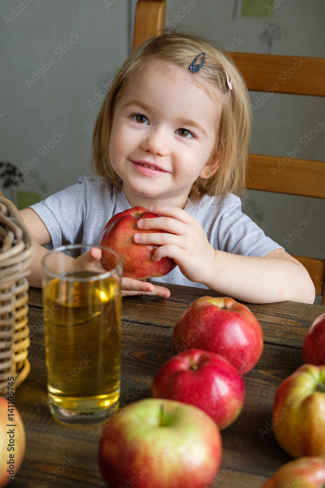 Fototapeta premium Cute little girl holding an apple