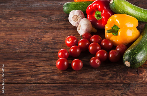 Fresh vegetables on brown wood background with copy space