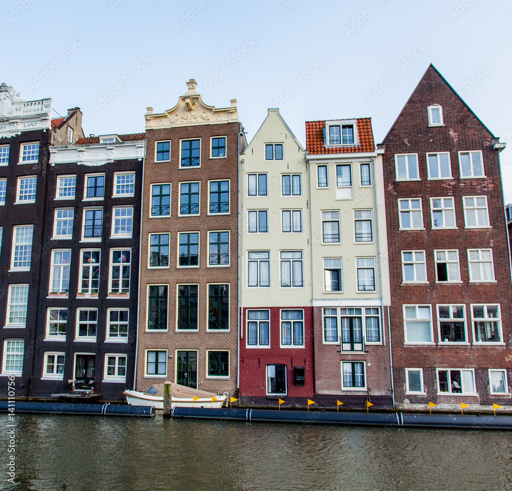 AMSTERDAM, NETHERLANDS - September 21, 2014: photo of beautiful view on chain of colorful houses and river