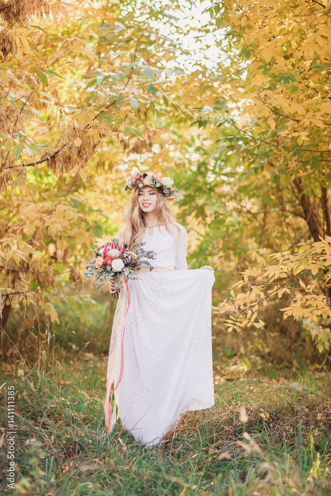 Beautiful blonde bride with a bouquet in bushes. Beautiful blonde bride with a bouquet in bushes.