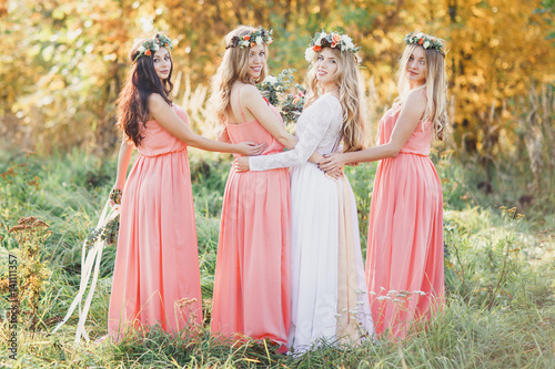 The bride and bridesmaids hugging. © Valery