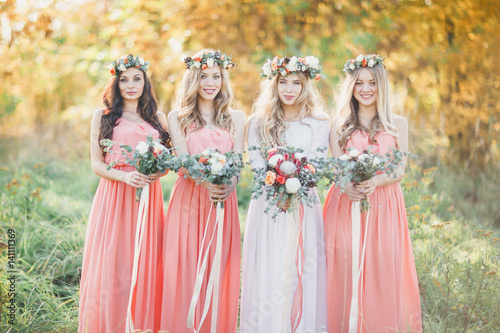 The bride and bridesmaids. A summer wedding outdoors.