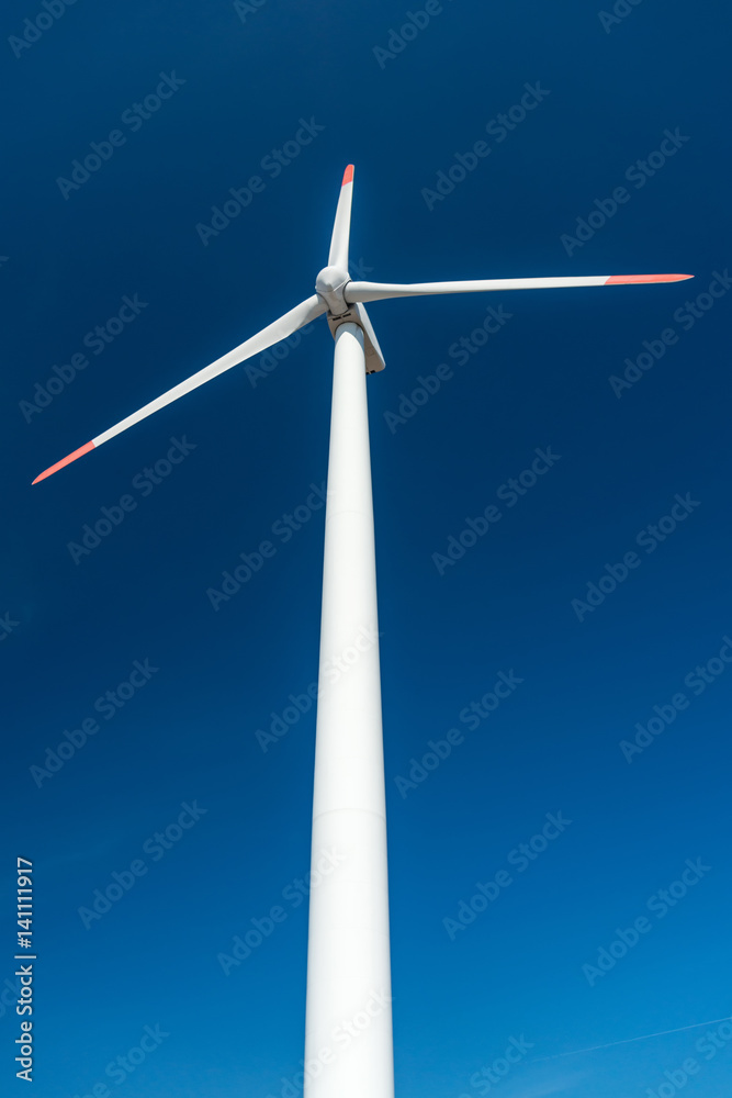 Wind turbines against a blue sky generating electricity Wind turbines against a blue sky generating electricity