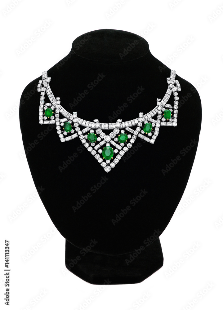 Pendant with green gem stones on black mannequin isolated on white Pendant with green gem stones on black mannequin isolated on white