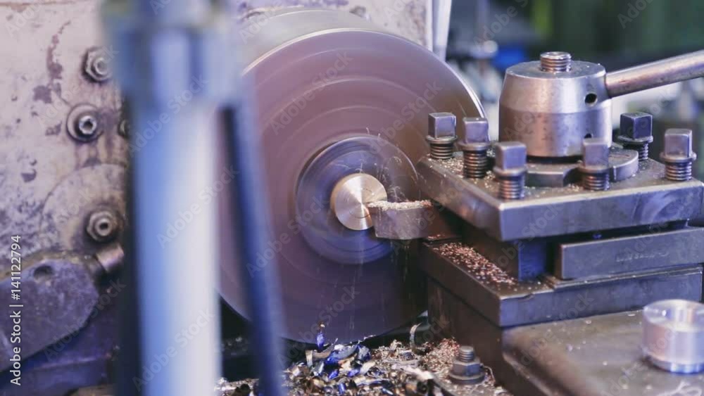 Metal working lathe a in factory. Machining process at workshop for repair. Cutting metal modern processing technology.