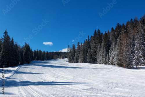 Corvara, Alta Badia winter view of ski slope with blue sky, no people
