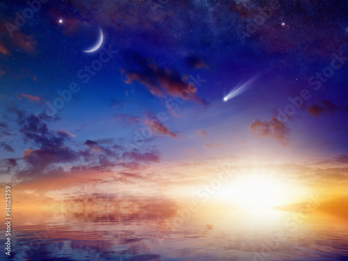 Bright comet, stars and crescent in sunset sky with reflection in sea