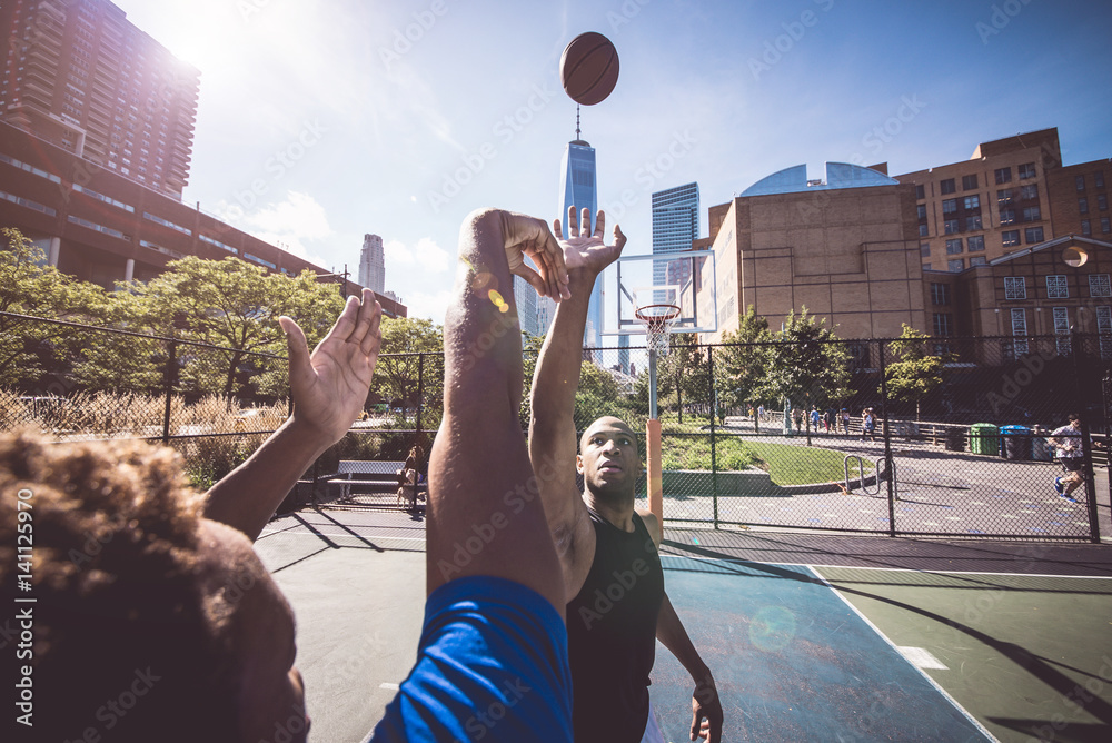 Fototapeta premium Two street basketball players playing hard on the court