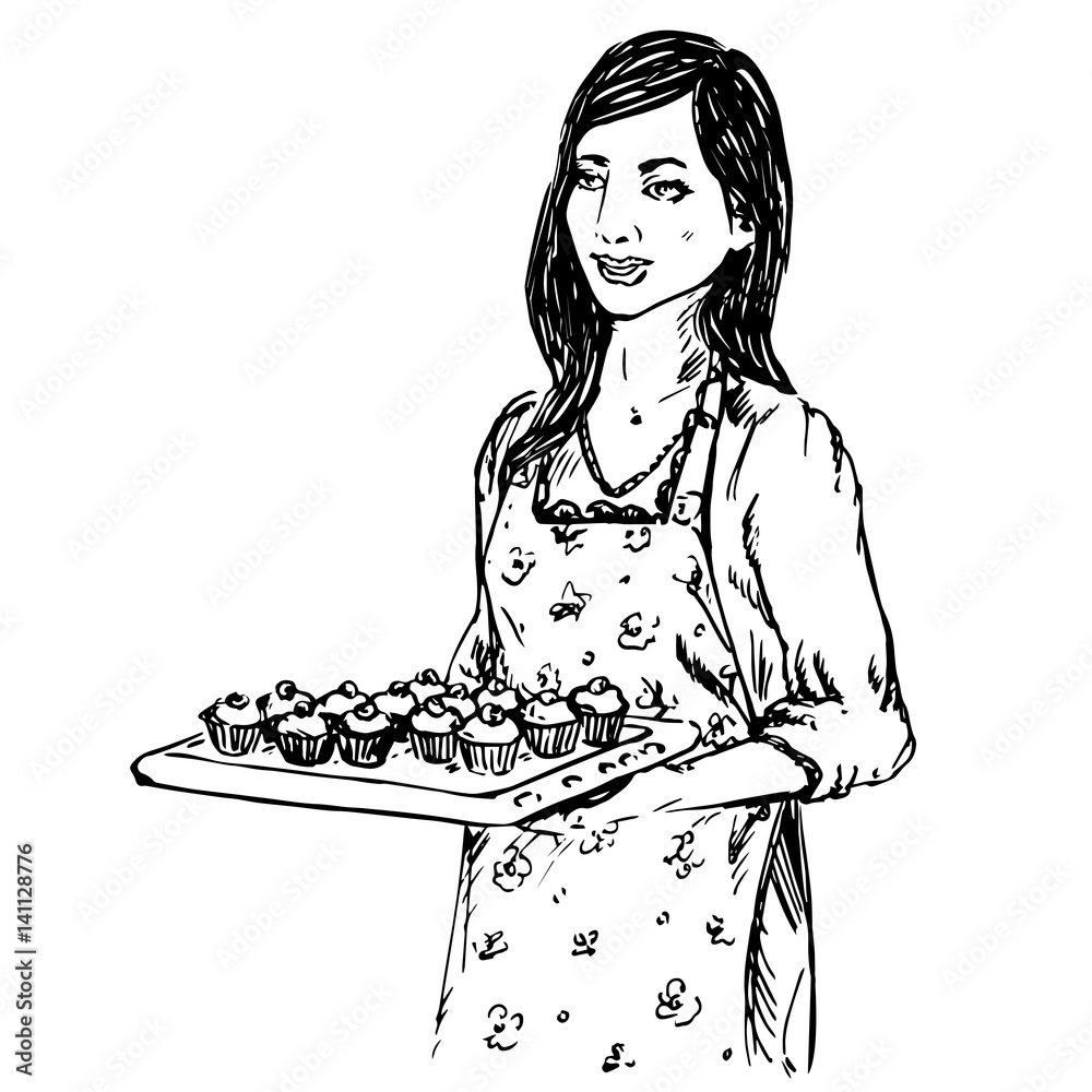 Young housewife dressed in apron, hold a baking tray with cupcakes ...