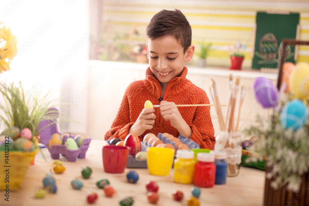 happy smiling young girl painting eggs in home kitchen happy smiling young girl painting eggs in home kitchen