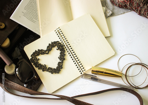 Beautiful opened notebook with wooden heart