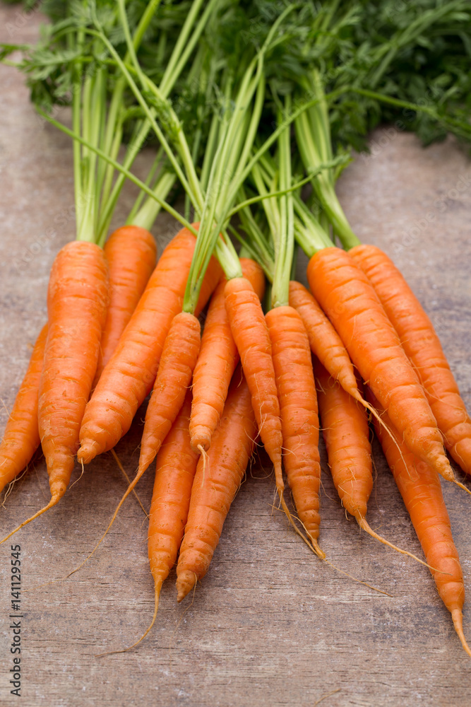 Fresh and sweet carrot on a grey wooden table. Fresh and sweet carrot on a grey wooden table.