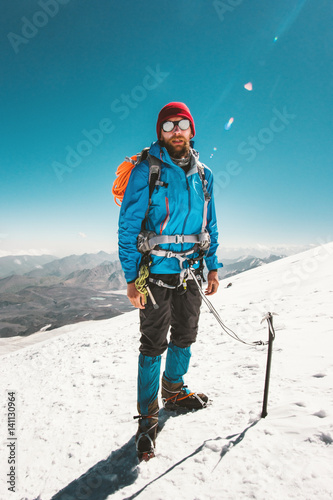 Man alpinist climbing in mountains glacier Travel Lifestyle endurance concept adventure active vacations outdoor mountaineering sport ice axe crampons alpinism equipment photo