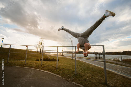 Teenager makes acrobatic moves in park parkour