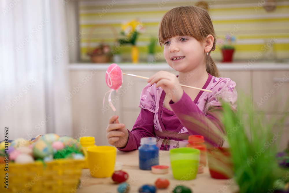 happy smiling young girl painting eggs in home kitchen happy smiling young girl painting eggs in home kitchen