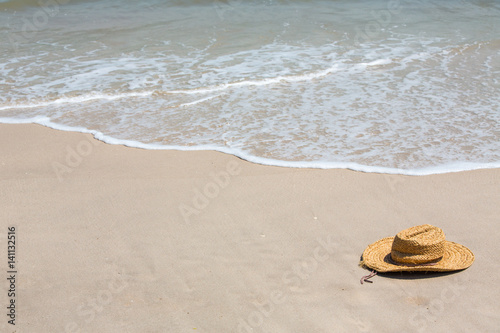 Straw hat on tropical beach