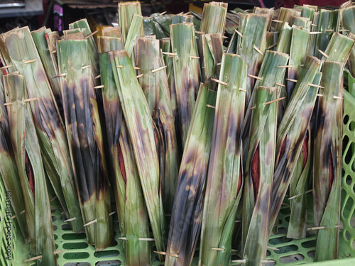 Traditional Malaysian local food called otak otak. Made from fish and flour covered with fresh banana leaves. 
 photo