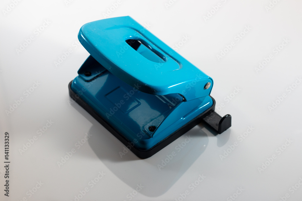Isolated blue paper punch against a white background Isolated blue paper punch against a white background