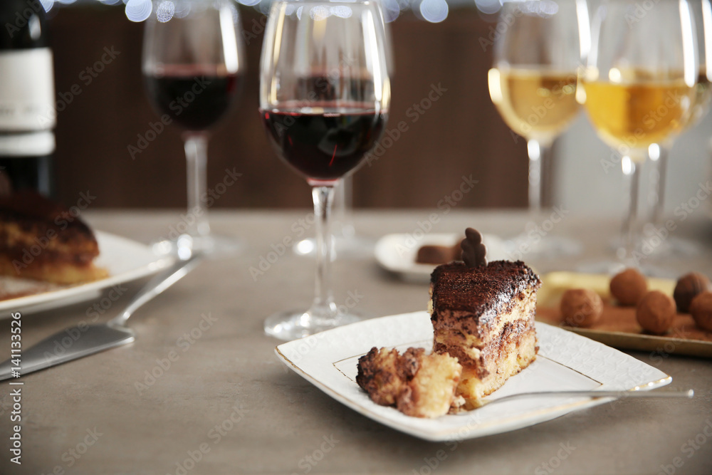Delicious chocolate desserts and wine on grey table