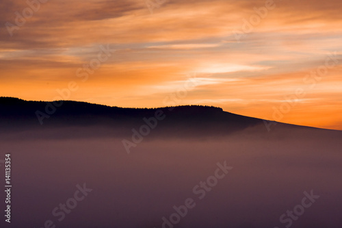 Spectacular sunrise through the mist at Underberg. Note the orange colors.