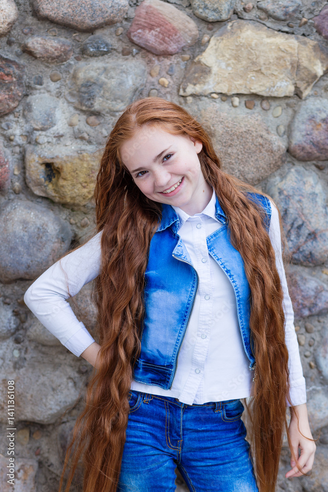 Beautiful redhead girl with long hair up to knees