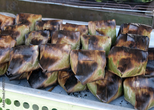 Satar is an exotic food very popular in peninsular Malaysia. It is made of raw fish and coconut, wrapped in fresh banana leaf. It has to be roasted before served. photo