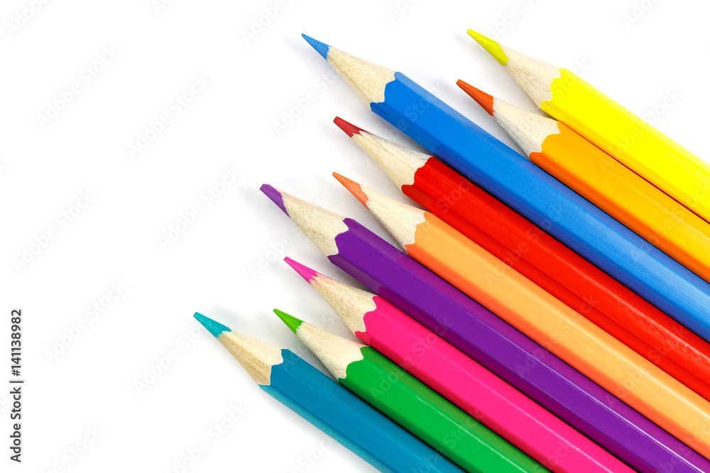 Chaotically placed wooden color pencils on a white background, top view Chaotically placed wooden color pencils on a white background, top view