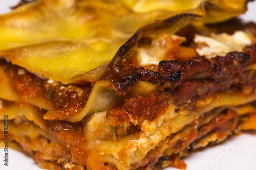 Traditional Italian lasagna with spicy tomato based ground beef and melted mozzarella cheese between layers of pasta