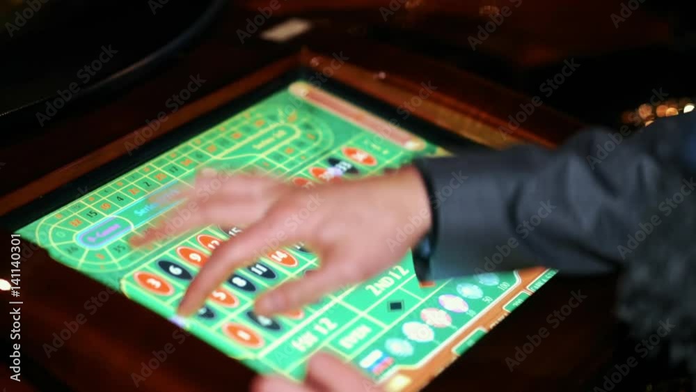 casino man playing electronic roulette. casino man playing electronic roulette.