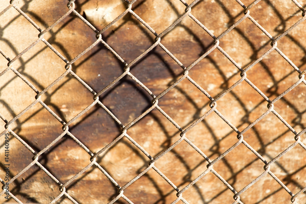 Fototapeta premium metal mesh on the wood background