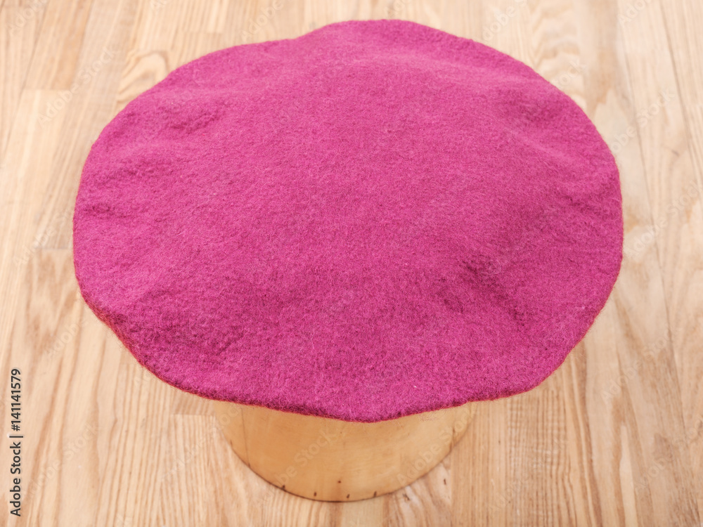 handmade felt beret is drying on wooden hat block handmade felt beret is drying on wooden hat block