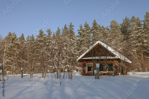 abandoned wooden house in winter forest