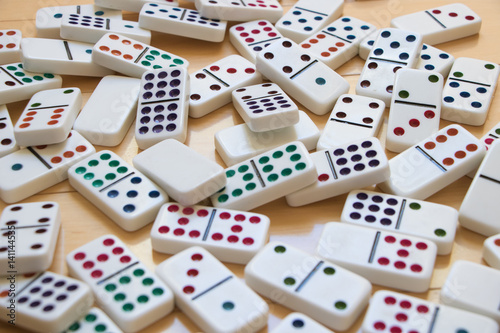Colorful Dominoes Spread Out on Wooden Floor
