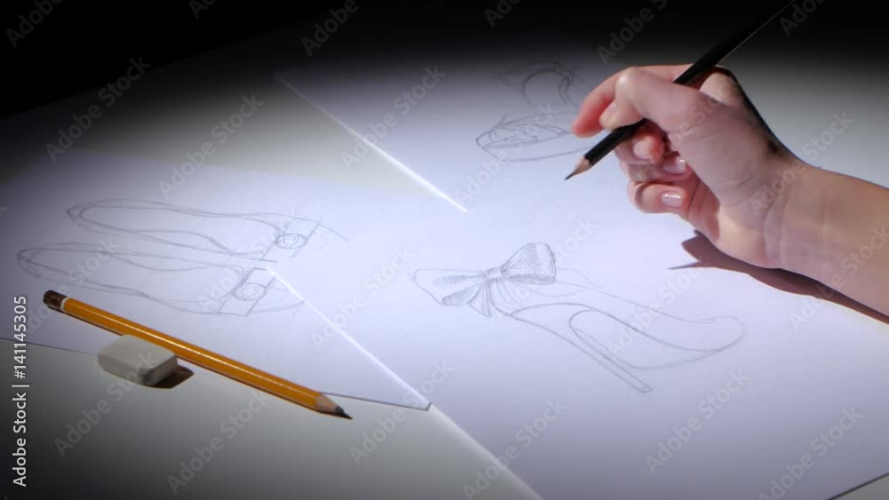 Shoe designer creates sketch for a youth brand. Close up