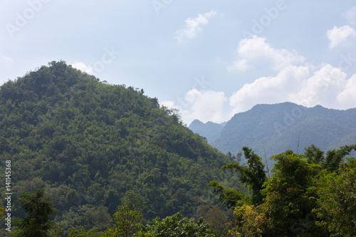 Large green hill in sunny weather in Thailand