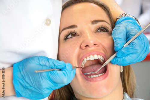 Dentist examining a patient's teeth in the dental office.