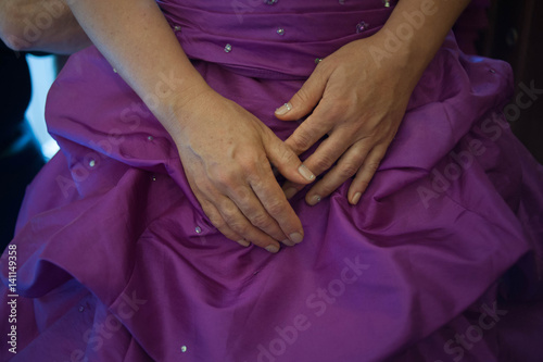 woman with hands on belly of pregnant woman