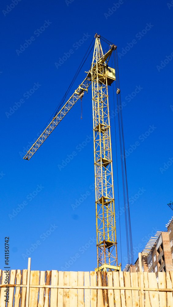 Construction crane against the sky heavy equipment