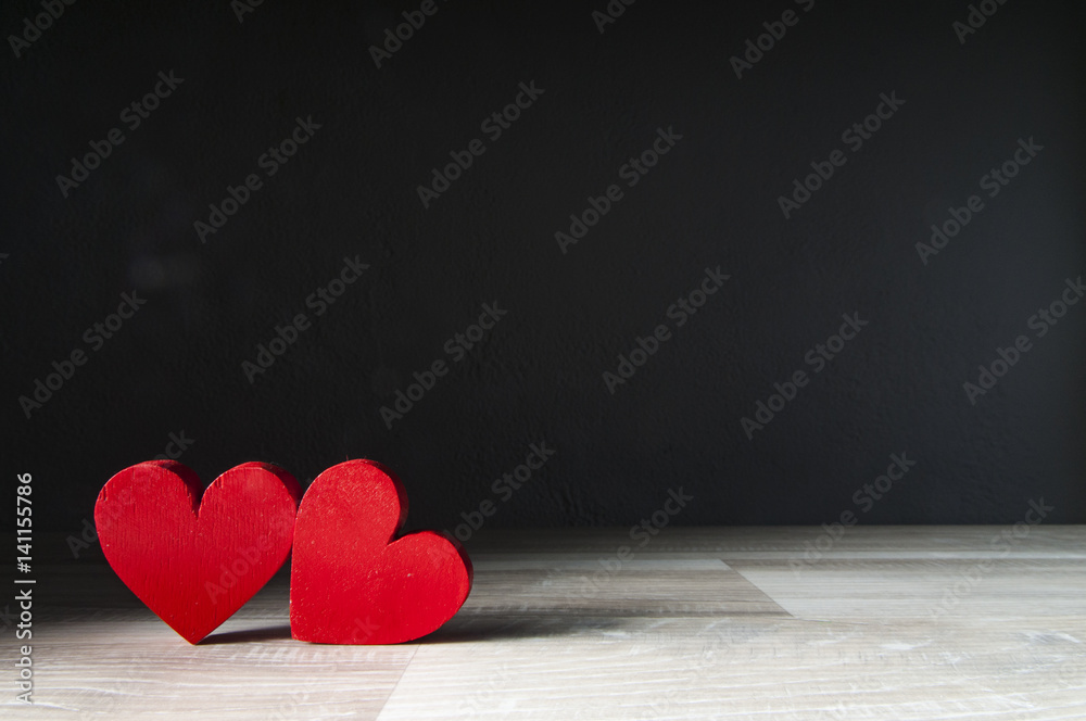 two hearts on dark wooden background two hearts on dark wooden background